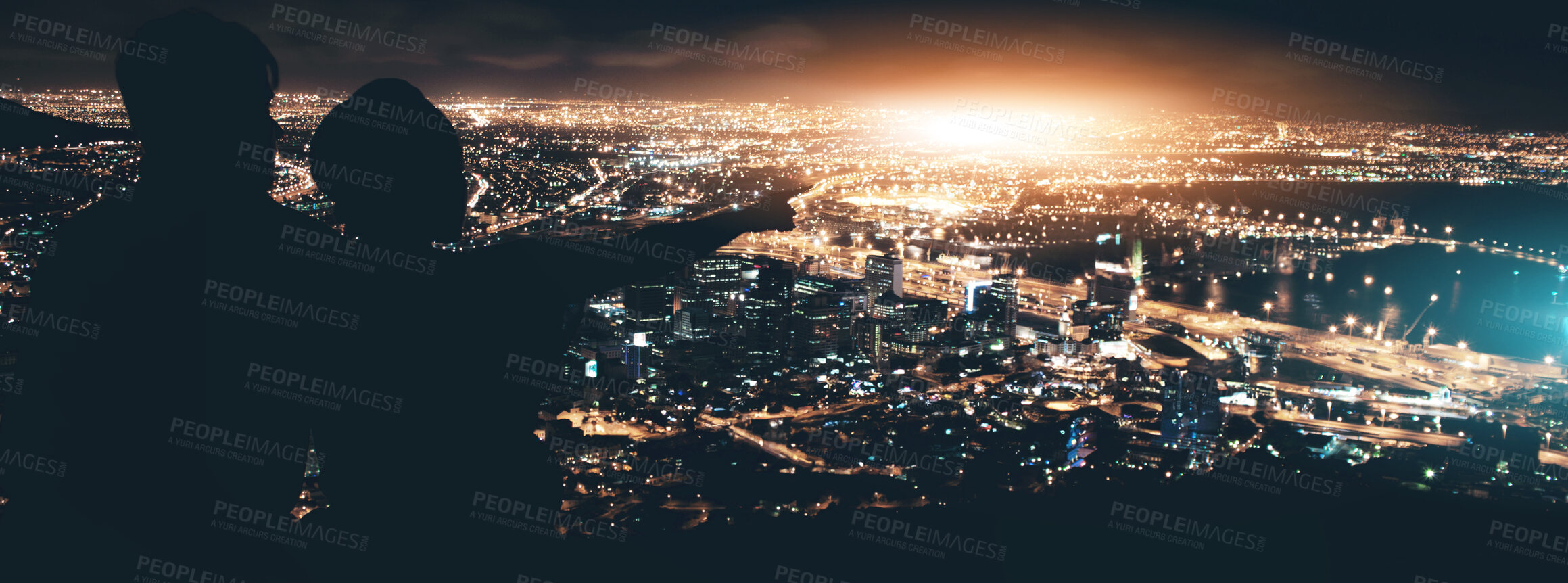 Buy stock photo Silhouette of a young couple enjoying the city nightscape