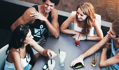 Buy stock photo Group of teens enjoying milkshakes and beverages while at an outdoor restaurant - high angle