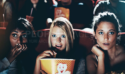 Buy stock photo Wow, popcorn and women in the cinema watching a movie for entertainment while eating a snack. Face, expression and food with shocked young friends in a theater audience to experience a film together