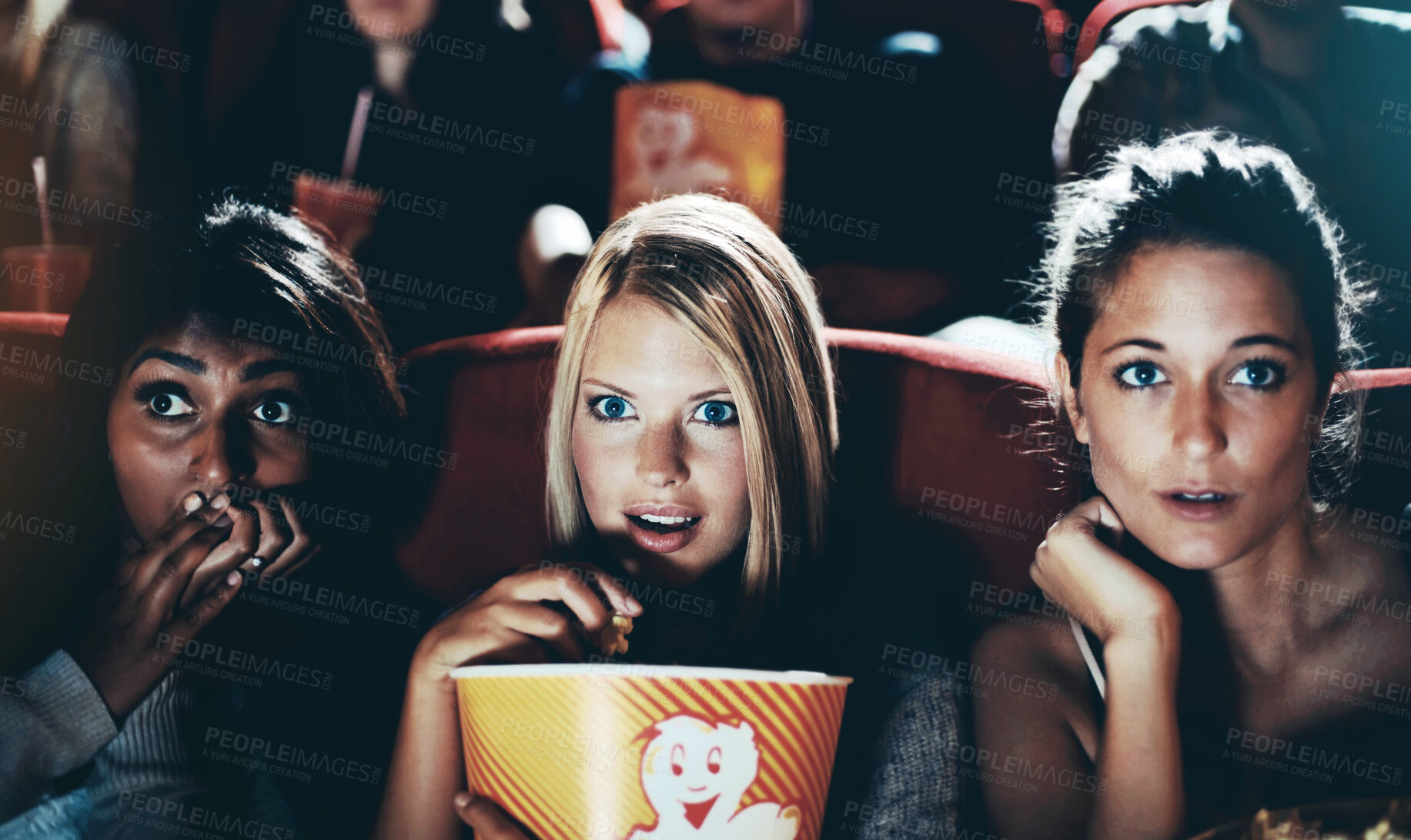 Buy stock photo Wow, popcorn and women in the cinema watching a movie for entertainment while eating a snack. Face, expression and food with shocked young friends in a theater audience to experience a film together