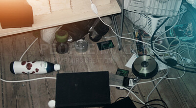 Buy stock photo Closeup of a messy bedroom with a foot sticking out from under dirty bed covers. Untidy teenager room with tangled wire, electronics, equipment and clutter lying on the floor next to an unmade bed