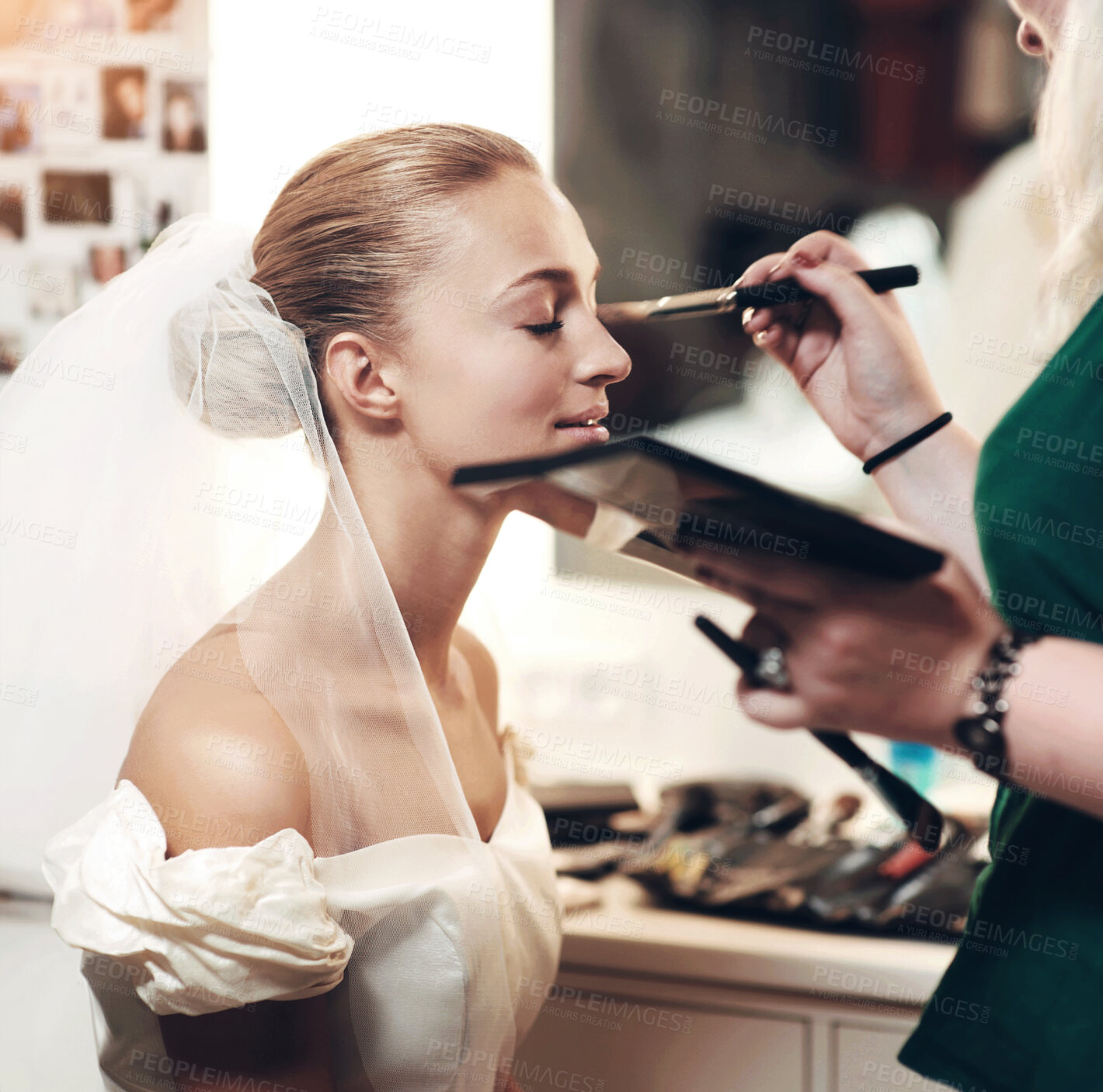 Buy stock photo A make-up artist applying make-up to a bride