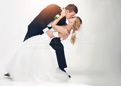 Buy stock photo Wedding, couple and love with a kissing  man and woman after marriage in studio on a white background. Young bride and groom at a celebration event together, happy and romantic in a dress and suit