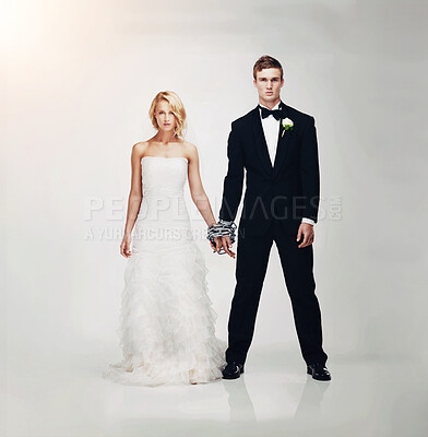 Buy stock photo Studio portrait of a serious-looking newlywed couple