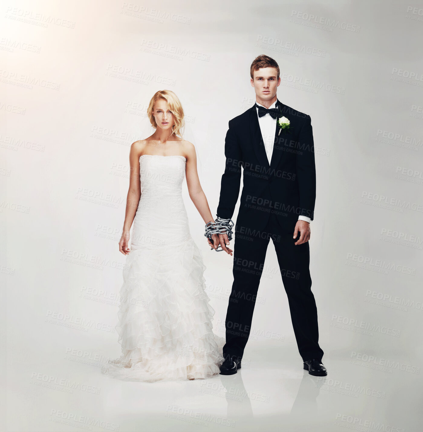 Buy stock photo Studio portrait of a serious-looking newlywed couple