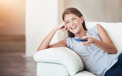 Buy stock photo Young woman watching tv and laughing while changing the channel