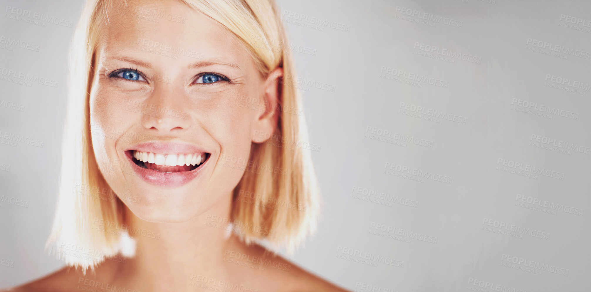 Buy stock photo Portrait of a pretty young woman with a large grin and copyspace beside her