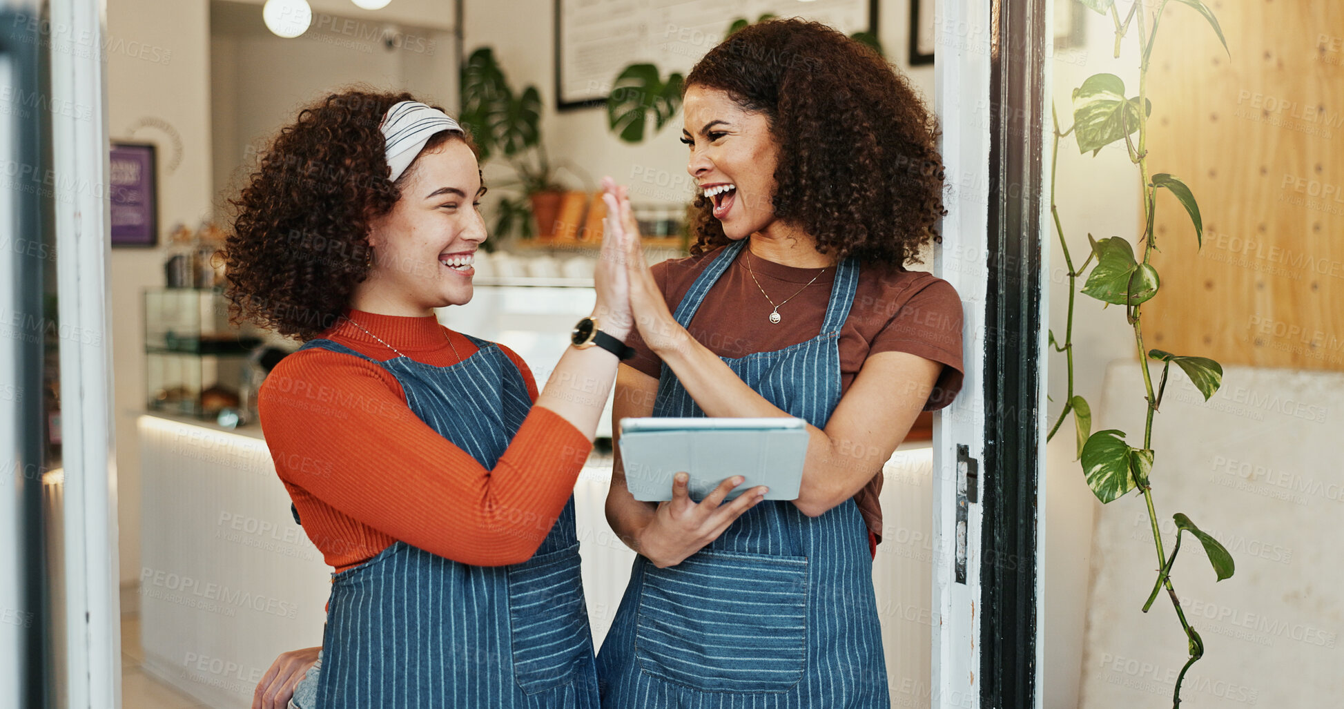 Buy stock photo Happy woman, waitress and high five with tablet for teamwork, success or sale together at cafe. Female person or employees touching hands with smile on technology for online startup at coffee shop