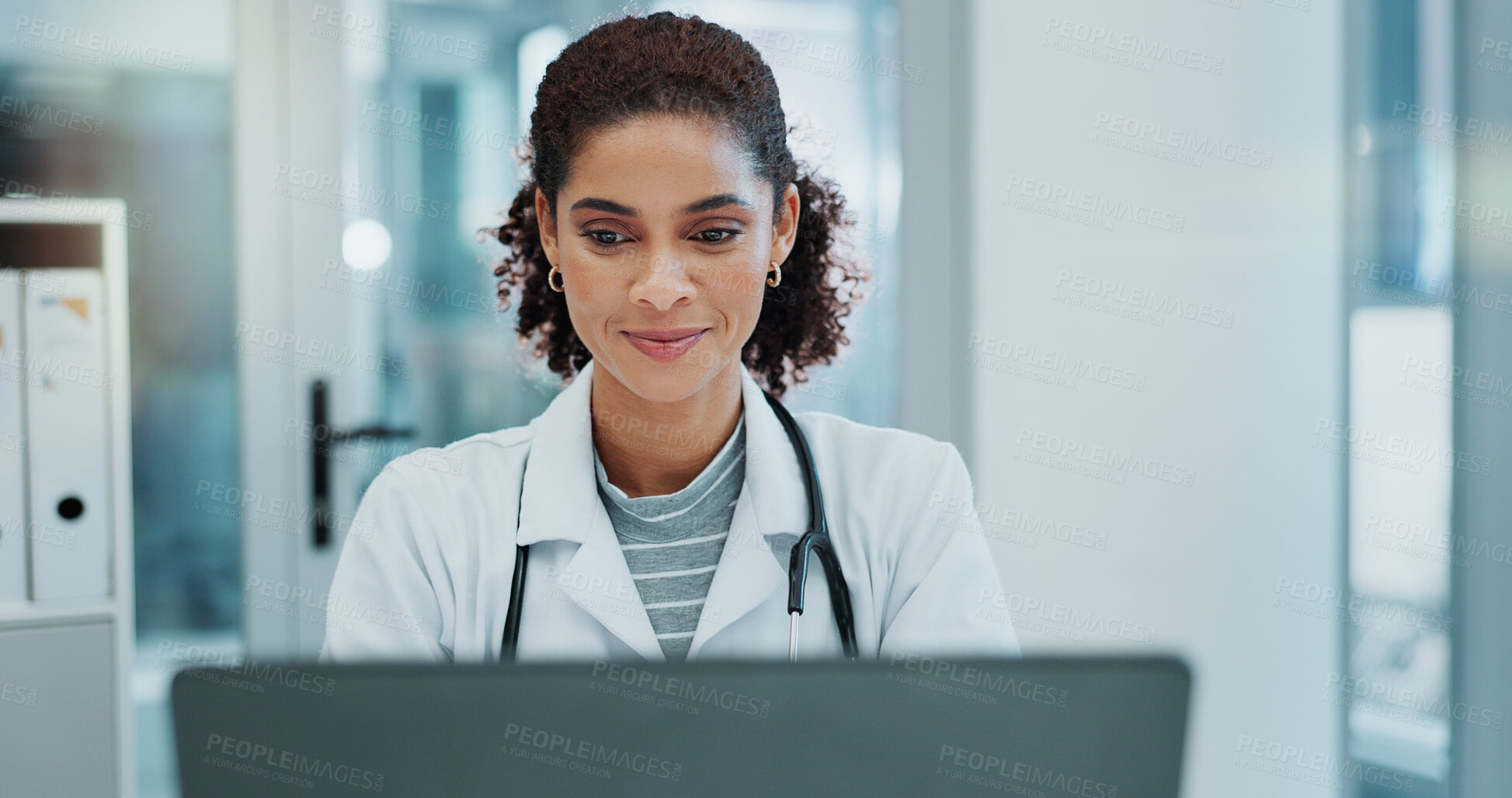 Buy stock photo Happy woman, doctor and typing with laptop for telehealth, medical study or news at hospital. Female person or healthcare employee on computer for online medicine, research or communication at clinic