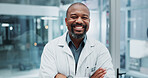 Doctor, portrait and confidence in hospital for healthcare, wellness and professional medical service. African man, surgeon and happy in clinic for health, medicine and consulting with crossed arms