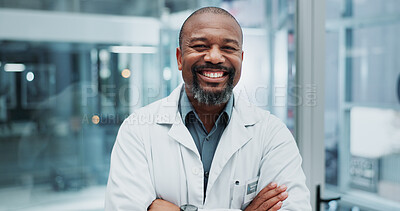 Buy stock photo Doctor, portrait and confidence in hospital for healthcare, wellness and professional medical service. African man, surgeon and happy in clinic for health, medicine and consulting with crossed arms