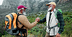 Happy, shaking hands or friends in nature hiking on mountain in outdoor adventure celebration in travel. Teamwork, winning or proud senior black people in forest for success, achievement or trekking