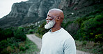 Black man, mature and smile in nature for fitness, peace and healthy body accomplishment. Senior person, happy and rest on mountain for hiking, wellness and scenic view from pathway or walking trail