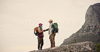 Buy stock photo Hiking, cliff and men on mountain with handshake for adventure, trekking and fitness. Travel, nature and mature people outdoors for wellness, walking and exercise on holiday, journey and vacation