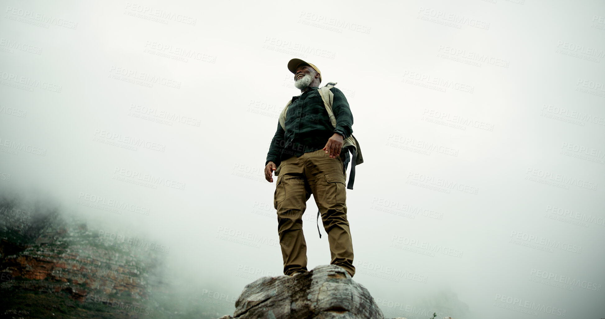 Buy stock photo Clouds, mockup or black man hiking in outdoor adventure or journey in nature for travel or walking. Hiker, healthy and person on mountain peak in woods for holiday, exercise or trekking to explore