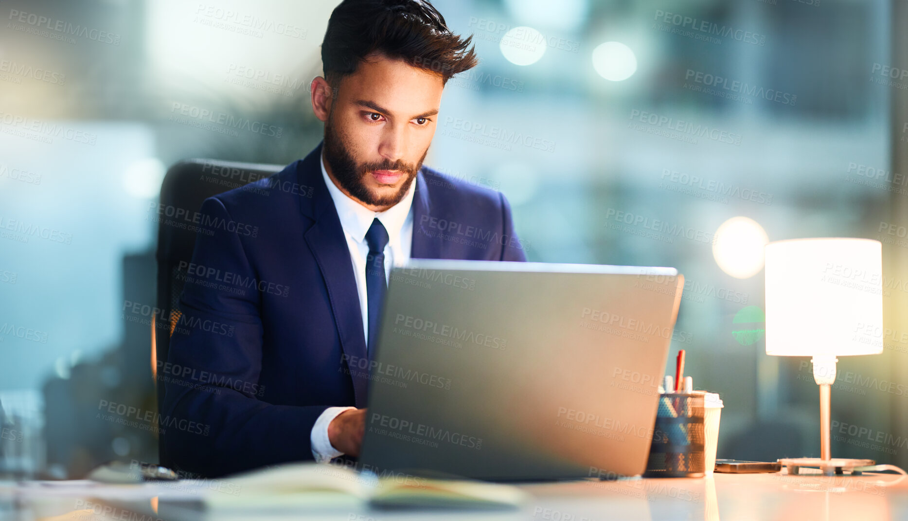 Buy stock photo Businessman, laptop and reading information in office for research, statutory review and legal policy. Attorney, computer and search for intellectual property rights, regulations and working at night