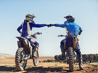 Buy stock photo Two motocross riders bumping fists before a race