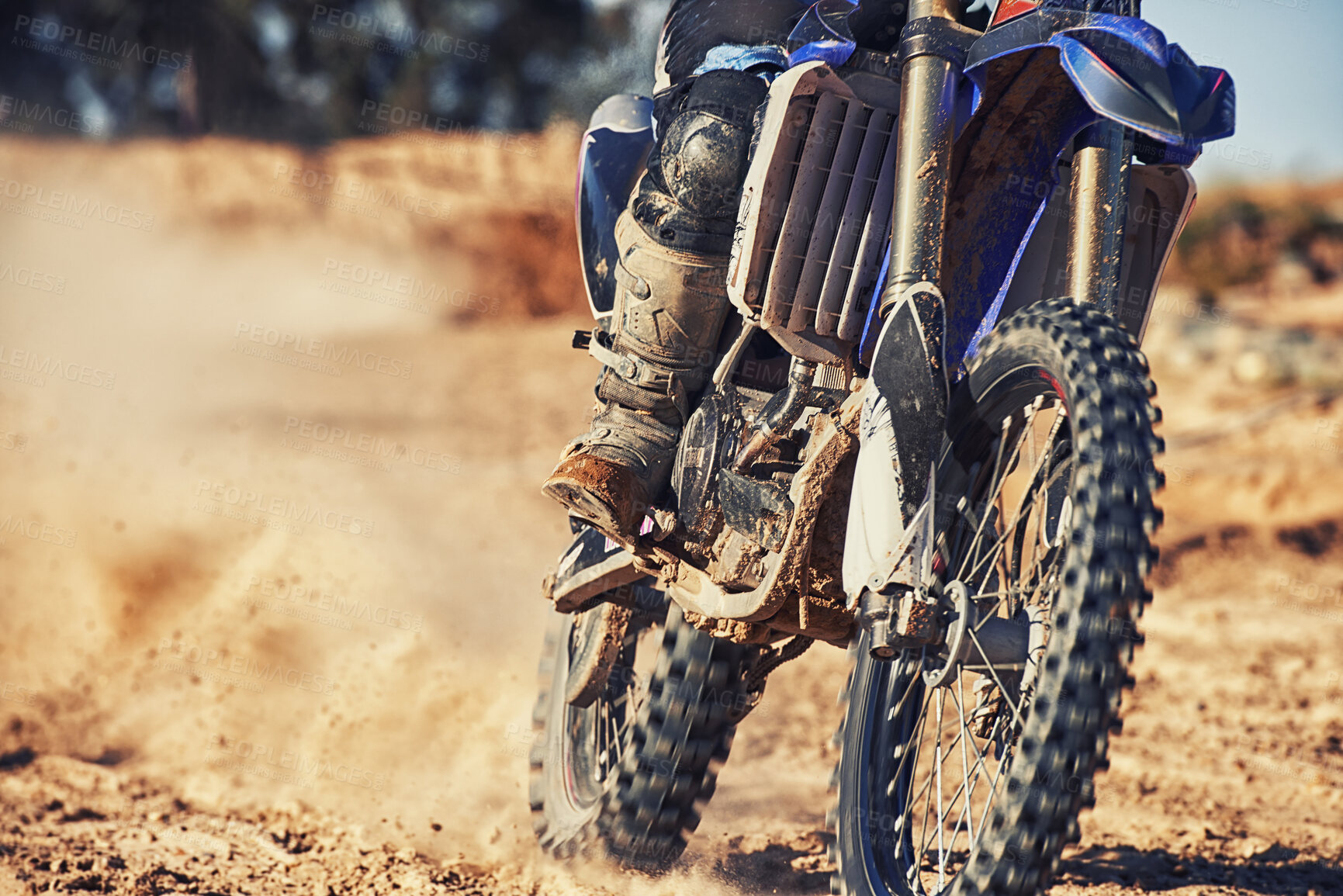 Buy stock photo Closeup, dirt track and wheels of motorcyclist with motorbike for race, extreme sports or outdoor competition. Legs of expert rider on bike, scrambler or sand course for off road rally challenge