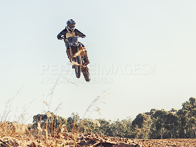 Buy stock photo Motorcycle, person and outdoor for jump in race on trail for competition, air and games on ground. Racer, motorbike and helmet for contest, motor cross and fast transport with flight in countryside