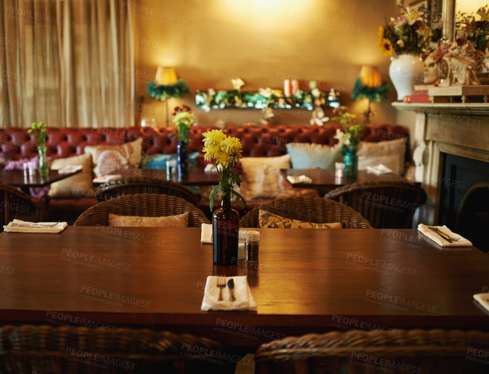 Buy stock photo Shot of a cozy home interior with a set dining table in the foreground