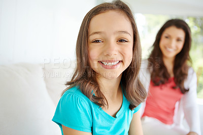 Buy stock photo Portrait, kid and relax on sofa at house with mother and daughter bonding, love and security of morning gratitude. Smile, girl and woman on weekend break, care and support together of childhood trust