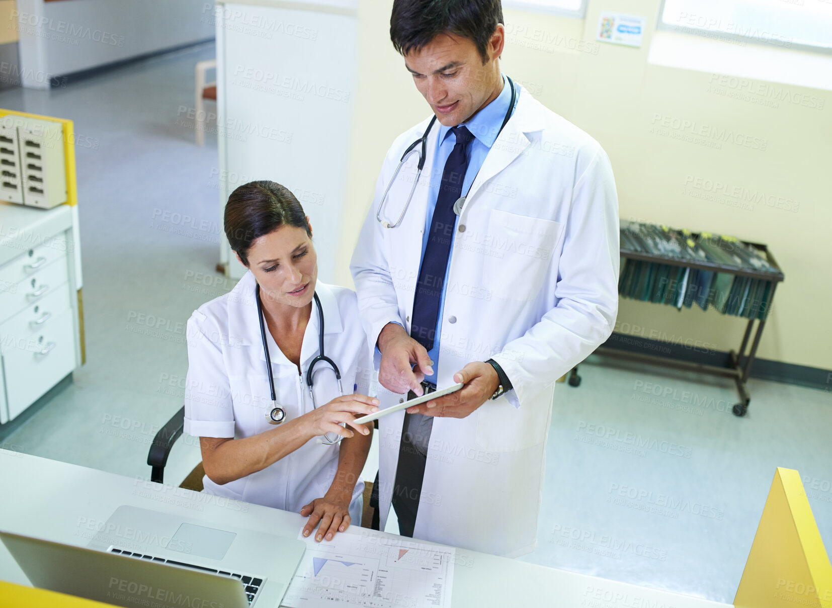 Buy stock photo Doctor, nurse and front desk in hospital on tablet, discussion and planning for patient schedule in clinic. Medical employees, healthcare service and people together, teamwork and professional
