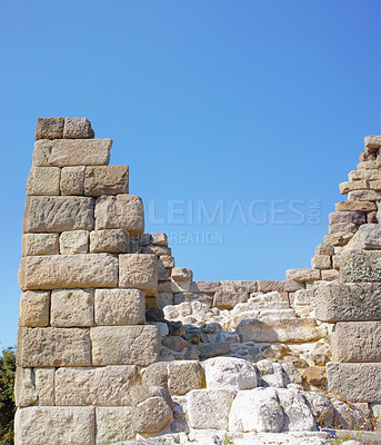 Buy stock photo Old city, wall and blue sky for history, road trip and turkey tourism travel with castle ruin. Myndos Gate, destination and scenery with stone, bricks and view for Bodrum summer adventure or explore