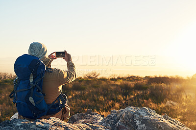 Buy stock photo Back, camera and hiking with man in mountains for break, memory or scenic view of nature. Earth, phone photograph and rest in summer with hiker person outdoor for adventure, fresh air or journey