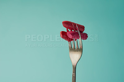 Buy stock photo Creative, fork and lipstick or cosmetics in studio for hazard or makeup safety, harmful ingredients and consumer awareness. Metal utensil, blue background and mockup space for health or beauty risk.