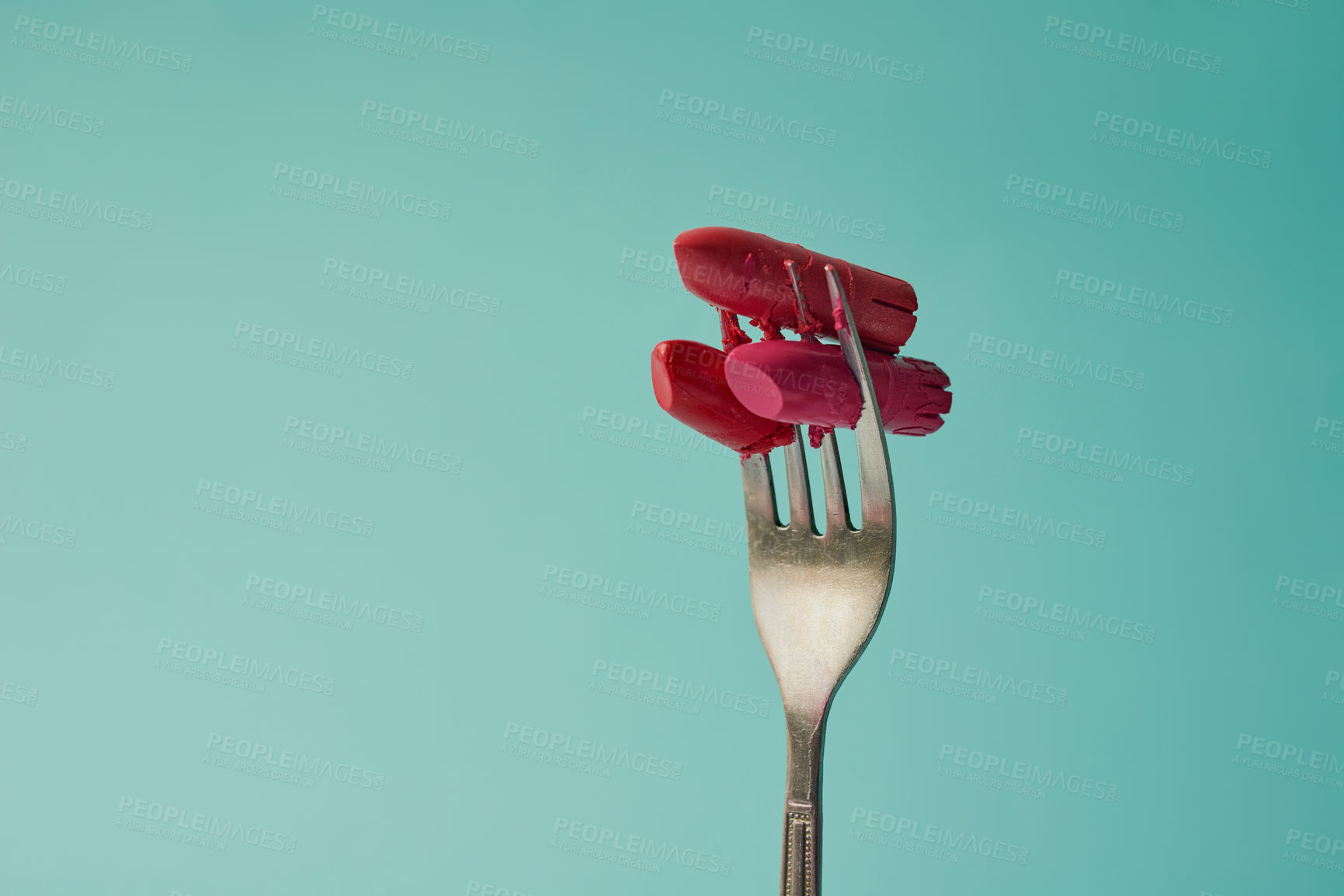 Buy stock photo Creative, fork and lipstick or cosmetics in studio for hazard or makeup safety, harmful ingredients and consumer awareness. Metal utensil, blue background and mockup space for health or beauty risk.