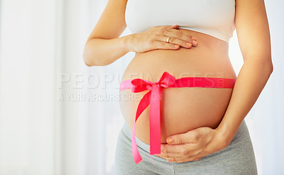 Buy stock photo Hands, pink ribbon and tummy for pregnant woman in home for gender reveal, symbol or care in morning. Person, mother and fabric for gift, present and icon for baby girl with love for stomach in house