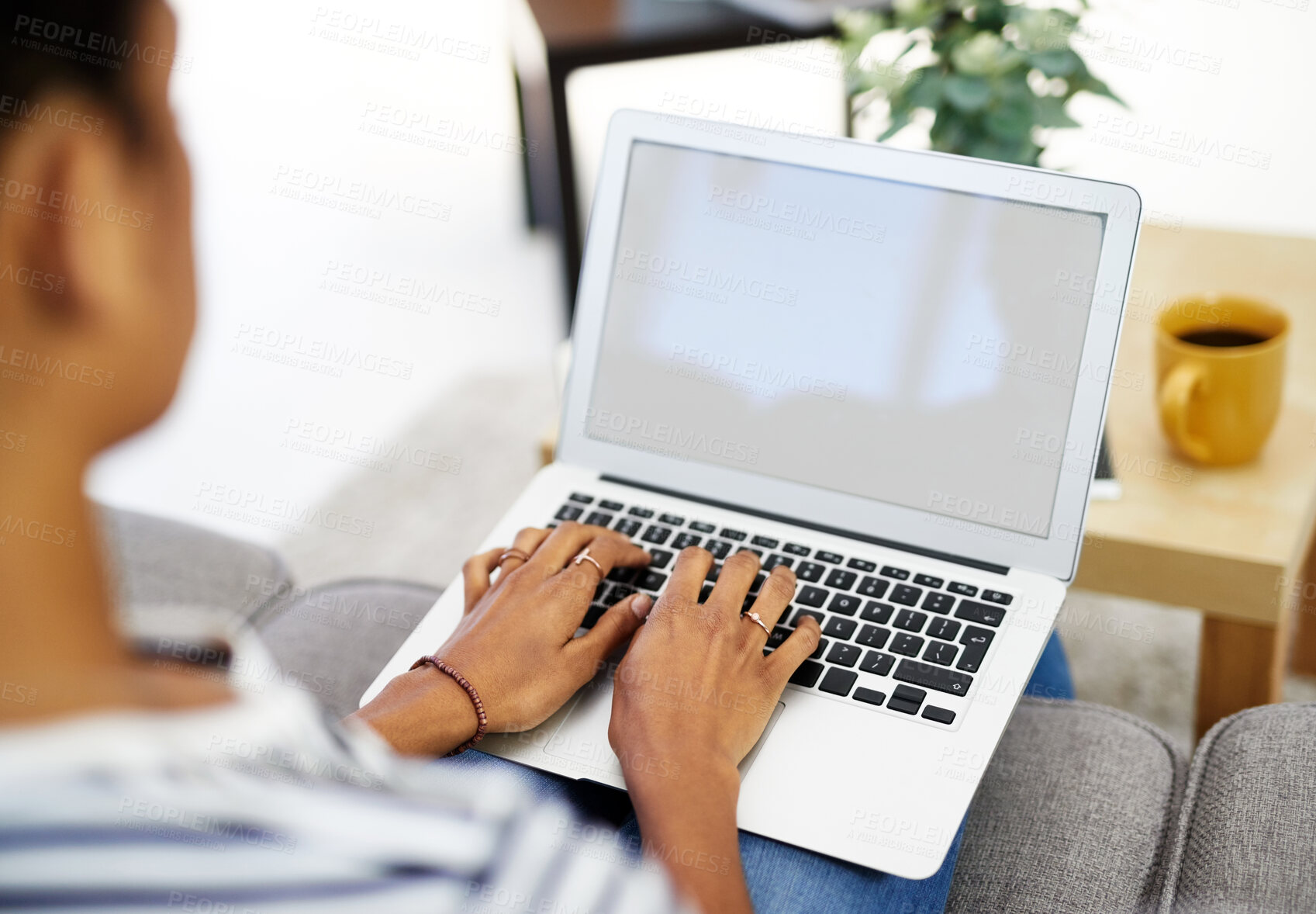 Buy stock photo Hands, screen and laptop on sofa in living room with person or typing or working from home. Education, student and fingers on keyboard for studying on couch in house or apartment with internet.