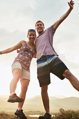 Buy stock photo Portrait, couple and hiking with freedom on mountain for achievement, adventure success or travel celebration. Below, people and trekking victory of explore winning, rock climbing and nature fitness