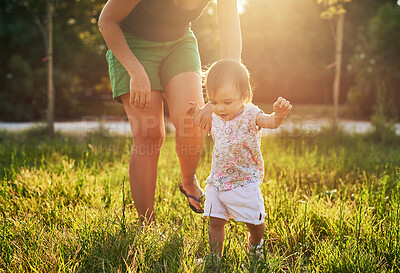 Buy stock photo Girl, baby and learning to walk on grass with progress, support or balance for development at family house. Child, toddler and steps for motor skills, growth or helping hand with sunshine in backyard