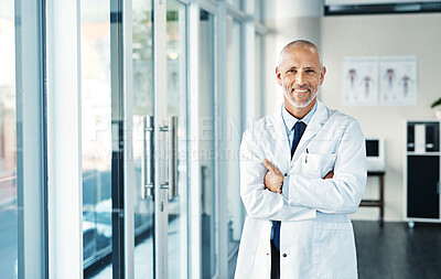 Buy stock photo Portrait of a mature doctor standing in a hospital