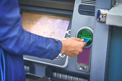 Buy stock photo Cropped shot of a woman making a transaction with her bank card at an ATM