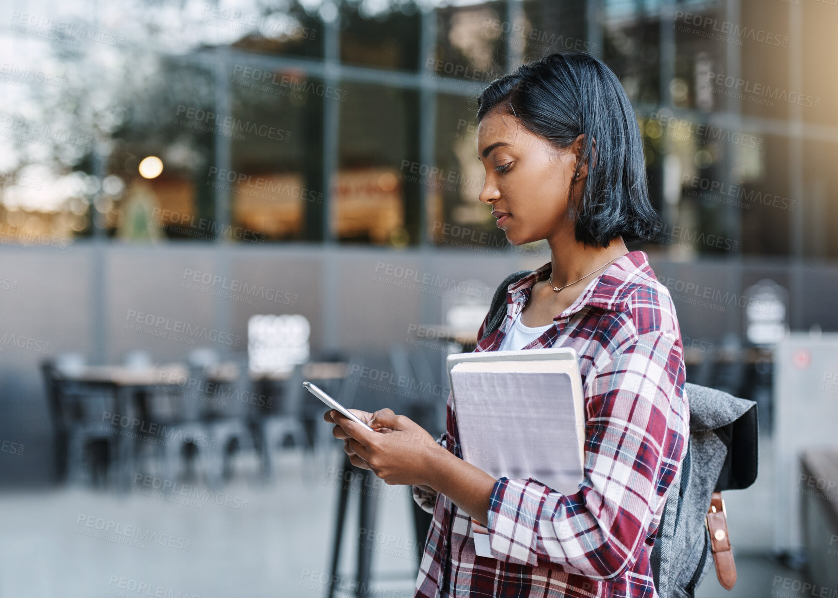 Buy stock photo Girl, university student and book with phone, business school and education with reading email. Indian person, smartphone and learning on mobile app with research for industrial psychology at college