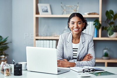 Buy stock photo Portrait of a young businesswoman working at her desk in a modern office