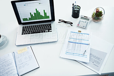 Buy stock photo High angle shot of a desk with various items on it in a financial company