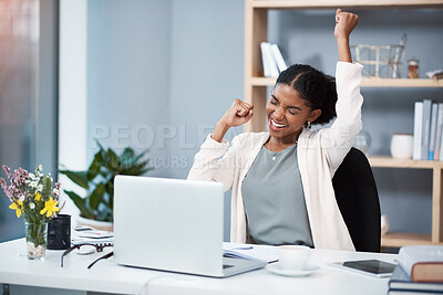 Buy stock photo Shot of a happy young businesswoman celebrating at her desk in a modern office