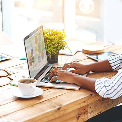 Buy stock photo Cropped shot of an unrecognizable young woman using her laptop on a wooden table