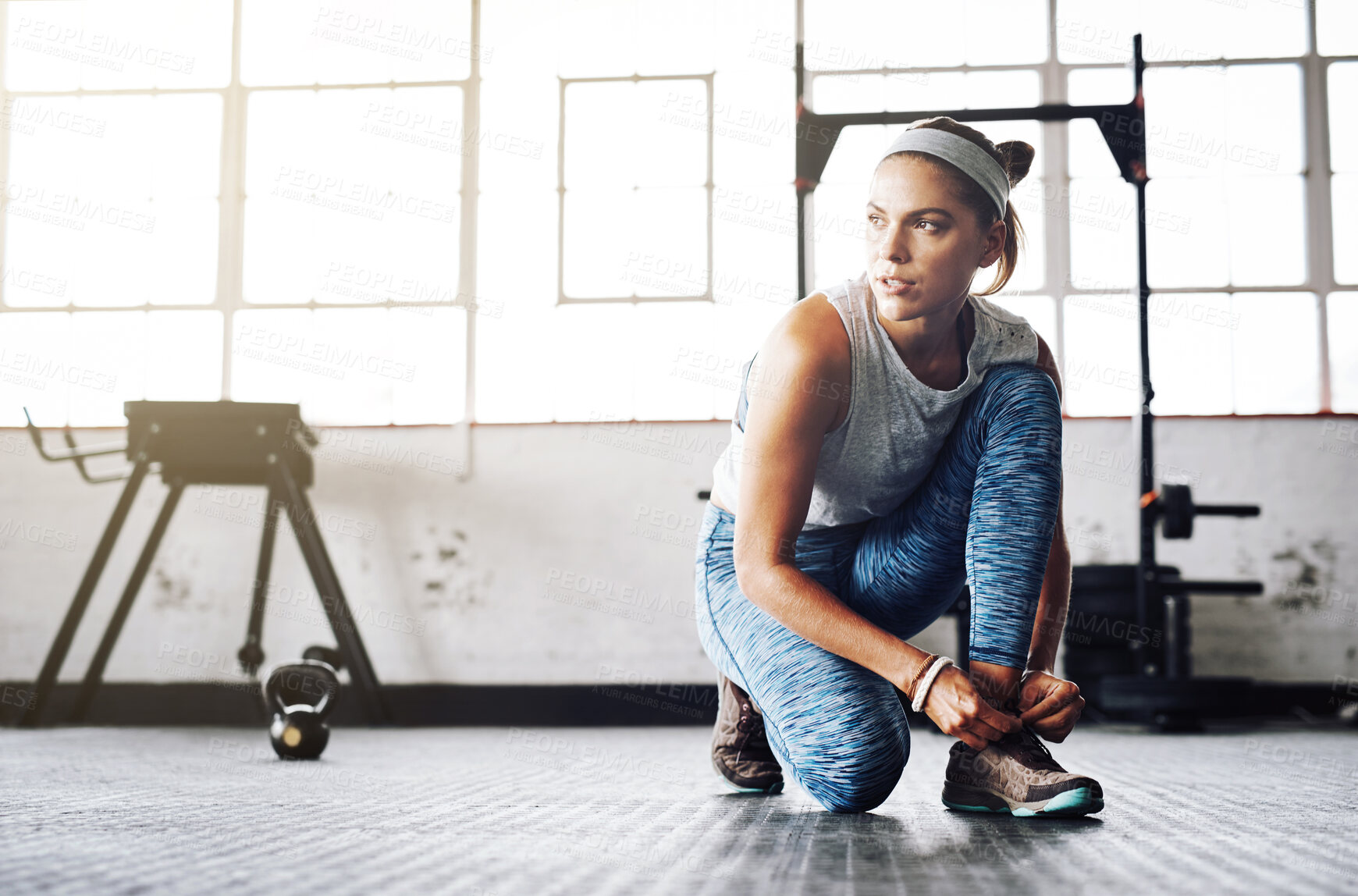 Buy stock photo Woman, tie and shoes on floor for fitness, exercise and workout goals in gym with commitment. Athlete, ready and shoelace on ground of sports club for training, health and wellness with motivation