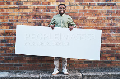 Buy stock photo Advertising, portrait and poster mockup of black man outdoor on city street with brick wall background. Sign, smile or space on banner for marketing with happy employee on sidewalk for recruitment