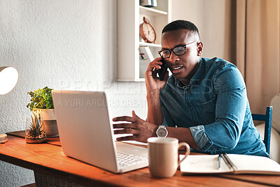 Buy stock photo Cropped shot of a handsome young businessman sitting alone in his home office and talking on his cellphone