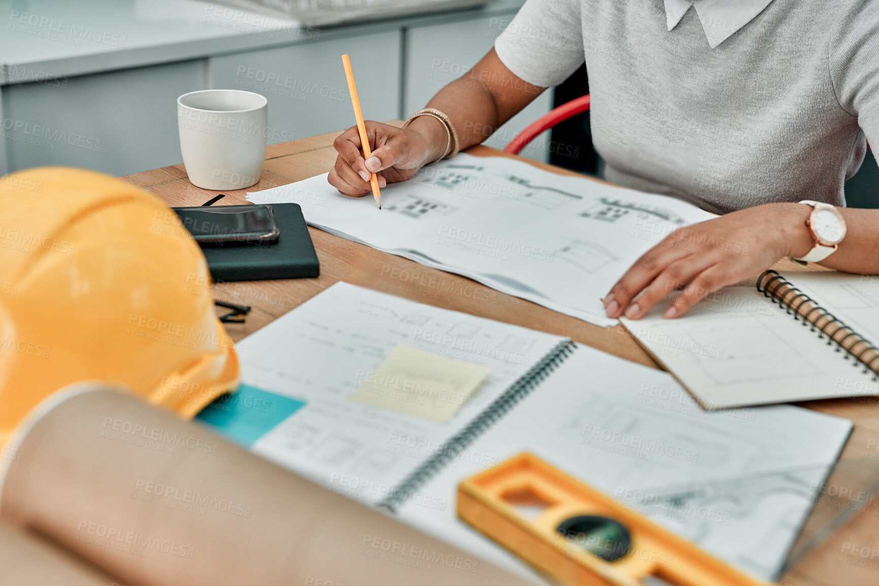 Buy stock photo Closeup shot of an unrecognisable architect working with blueprints in an office