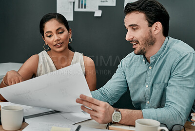 Buy stock photo Shot of two architects working with blueprints in an office