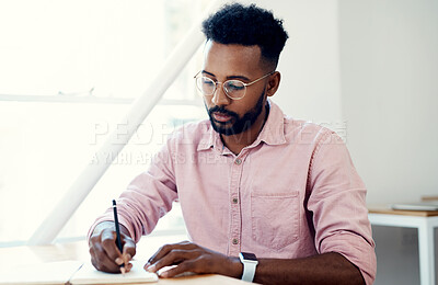 Buy stock photo Creative, black man and writing on book in office with notes of schedule, reminder and agenda for information of story. Journalist, record quotes and facts of brainstorming, script and project