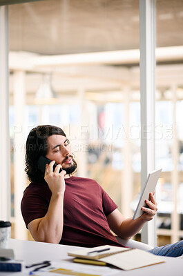 Buy stock photo Man, talking and phone call while reading tablet in web design office for collaboration, negotiation and information update. Programmer, coder or developer on communication technology for it solution