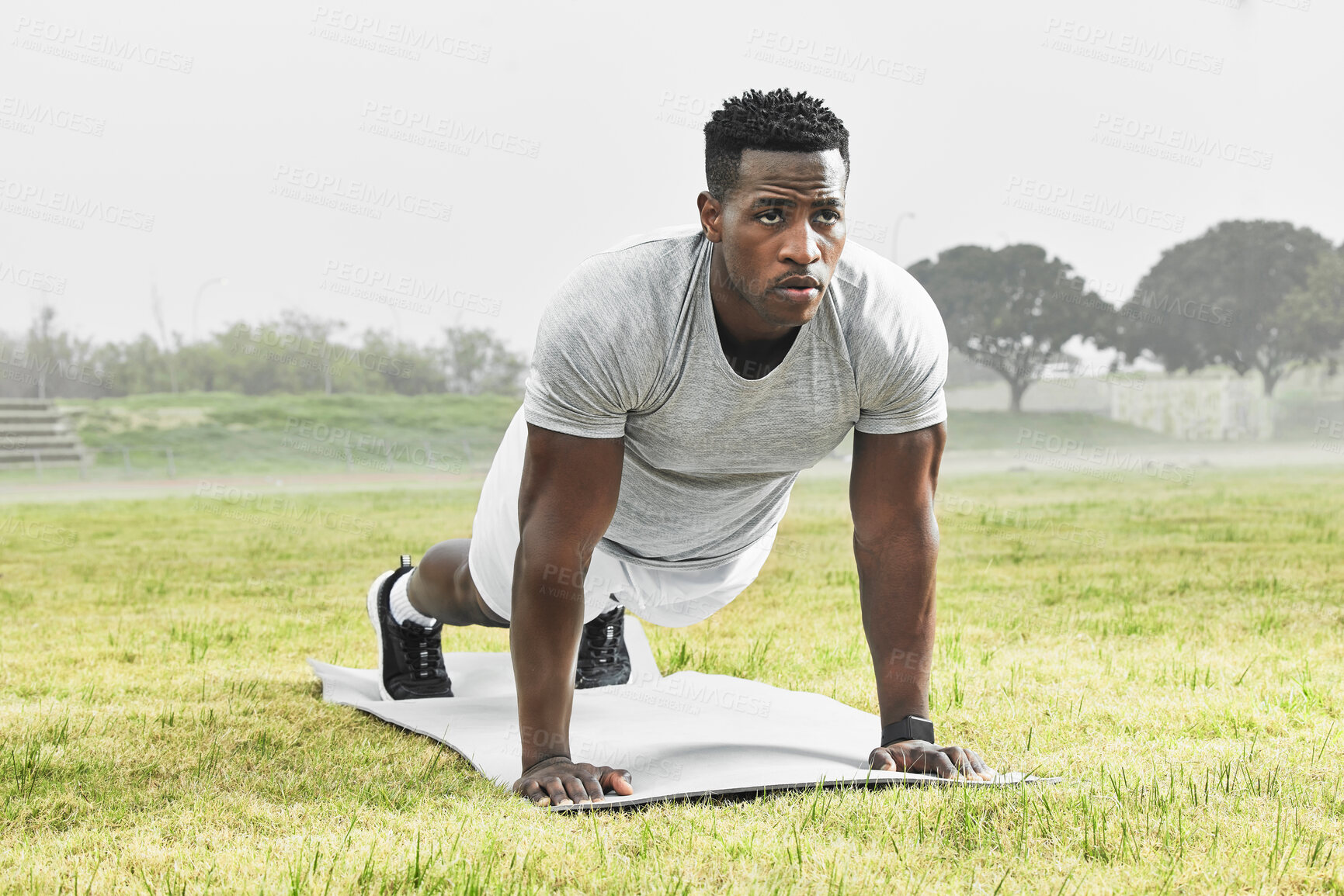 Buy stock photo Nature, fitness and black man with push up workout for arm muscles, strength and health. Sports, fog and African athlete with plank exercise for core activity on grass in outdoor park or field.