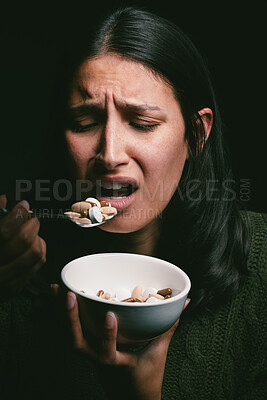 Buy stock photo Woman, stress and pills for health in studio, medicine and drugs treatment for bulimia on black background. Female person, anxiety and bowl of tablets for appetite, overdose and capsule for psyche